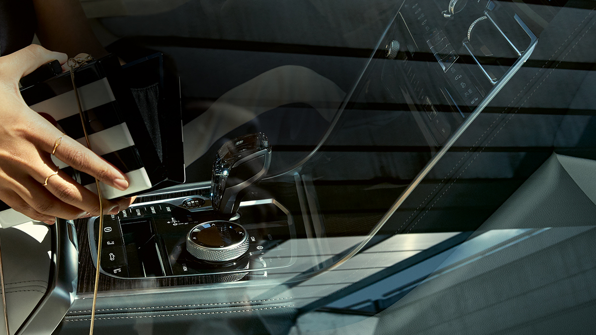 Interior del BMW M850i xDrive, aplicación de cristal ‘CraftedClarity’, mujer con bolso abierto. Interior del BMW M850i xDrive, aplicación de cristal ‘CraftedClarity’, mujer con bolso abierto.